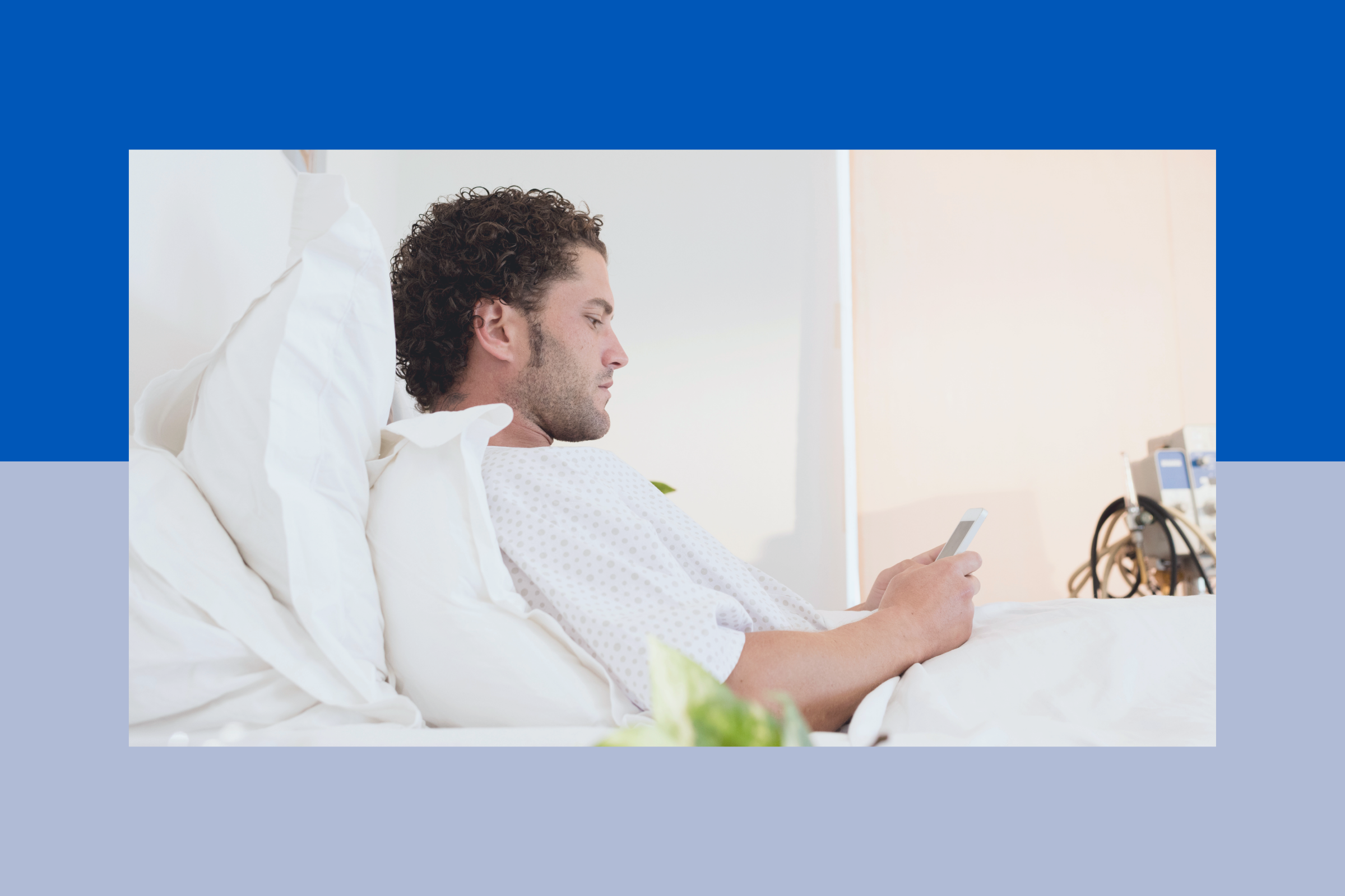 Patient looking at phone in hospital bed